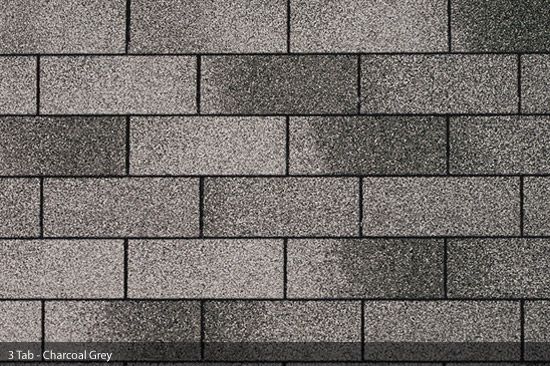 A close up of a brick wall with a gray brick in the middle.
