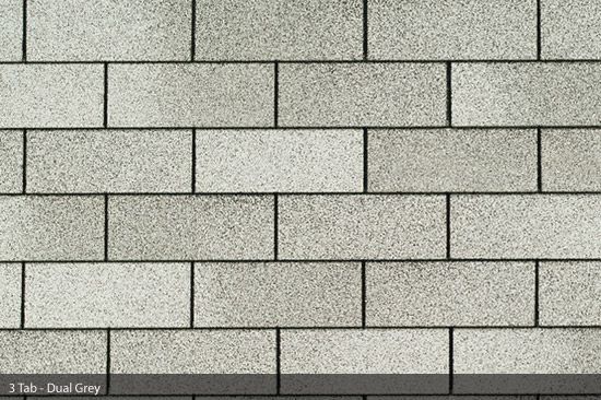 A close up of a brick wall in a gray color.