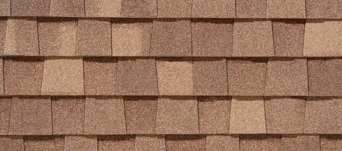 A close up of a wooden roof with shingles.