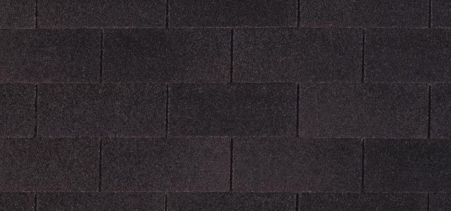 A close up of a black roof tile texture.