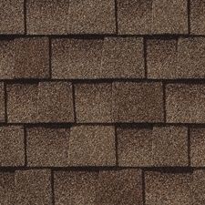 A close up of a row of brown shingles on a roof.