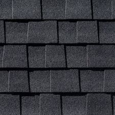 A close up of a row of gray shingles on a roof.