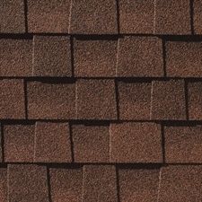 A close up of a row of brown shingles on a roof.