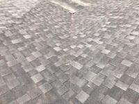 A close up of a gray shingle roof