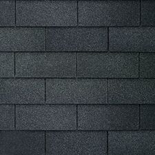 A close up of a row of black shingles on a roof.