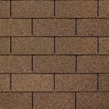 A close up of a brick wall with shingles on it.