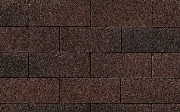 A close up of a brick wall made of brown bricks.