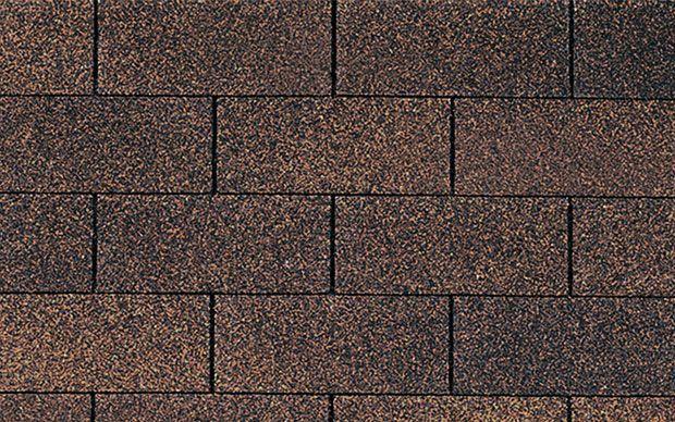 A close up of a brick wall made of brown bricks.