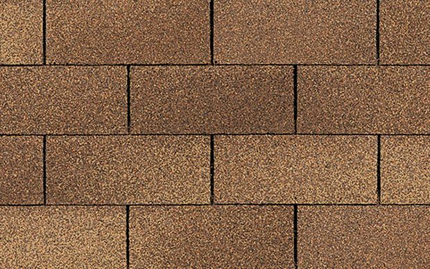 A close up of a brick wall made of brown bricks.