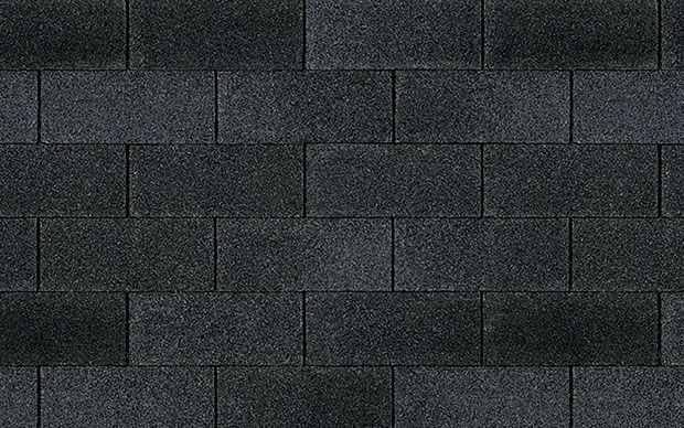 A close up of a row of black shingles on a roof.