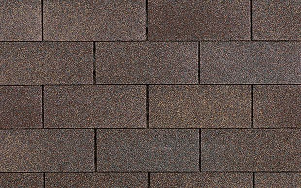 A close up of a brick wall made of brown bricks.