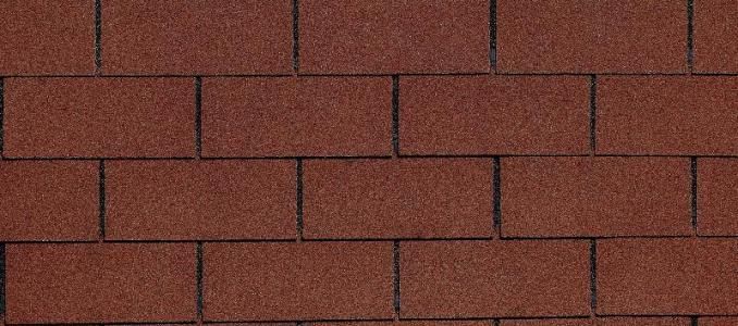 A close up of a row of red bricks on a roof.