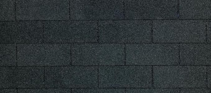 A close up of a row of black shingles on a roof.