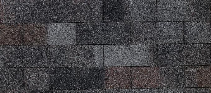 A close up of a roof with a lot of shingles on it.