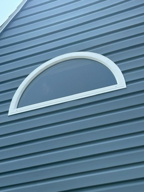 A half round window on the side of a building