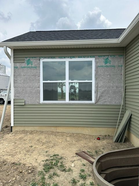 A house with a large window on the side of it.
