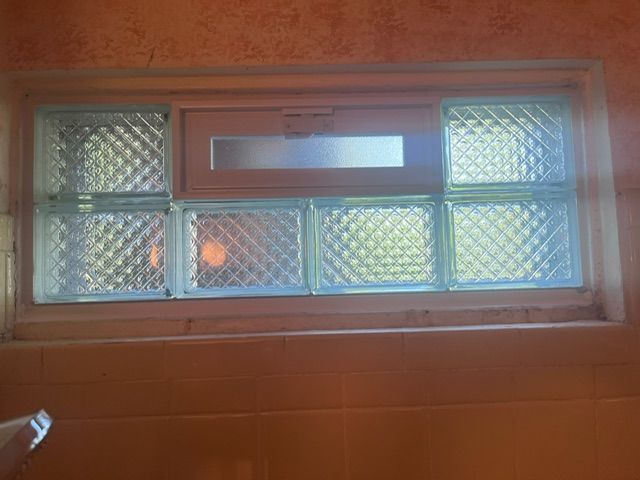 A window with a sliding glass door in a bathroom.