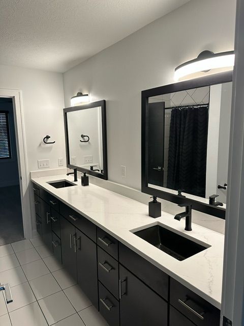 A bathroom with two sinks and two mirrors