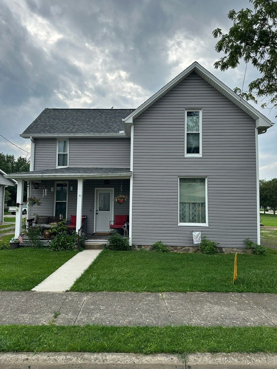 A gray house with a porch and a gray roof