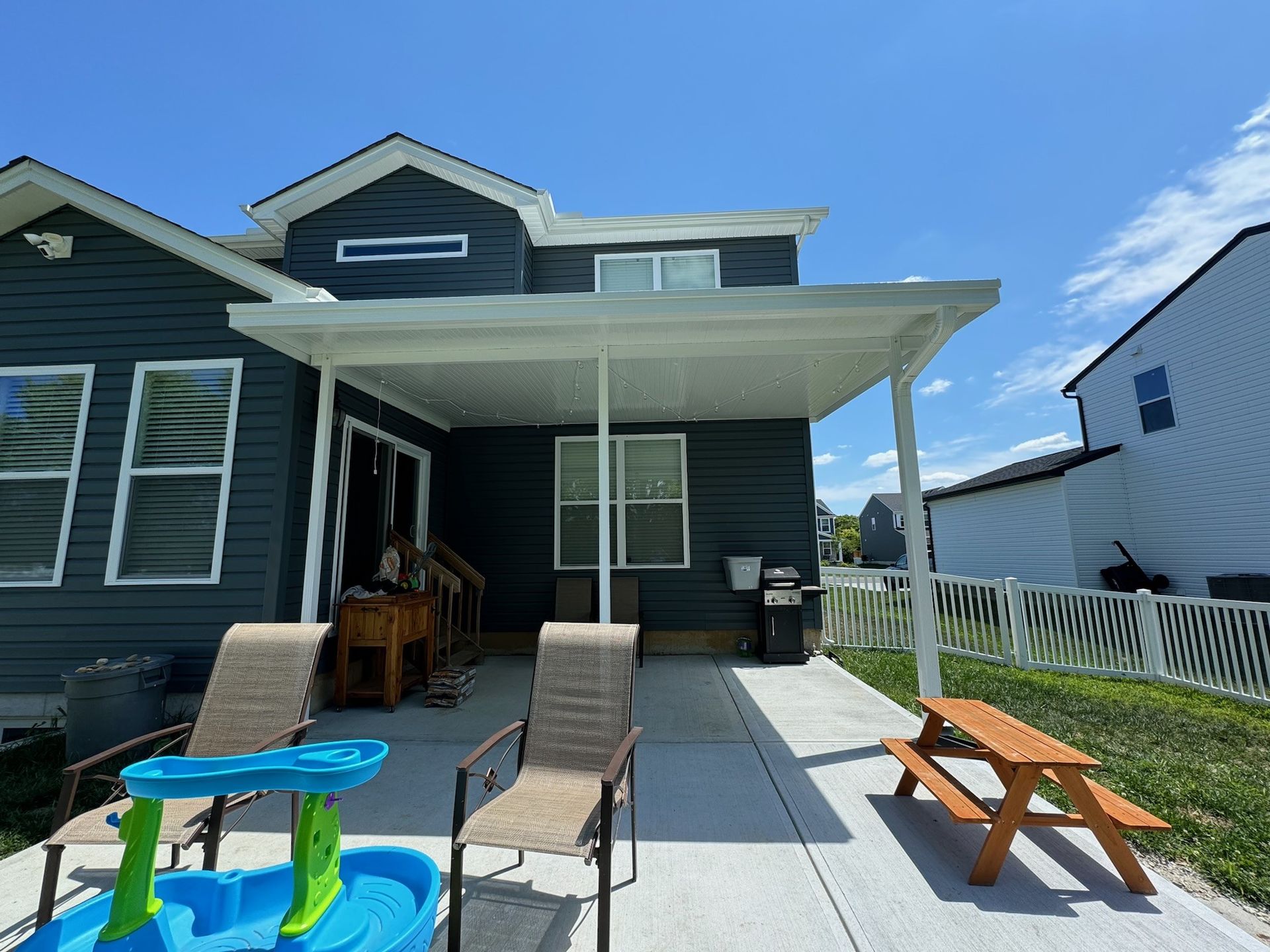 A brick house with a porch and a white railing