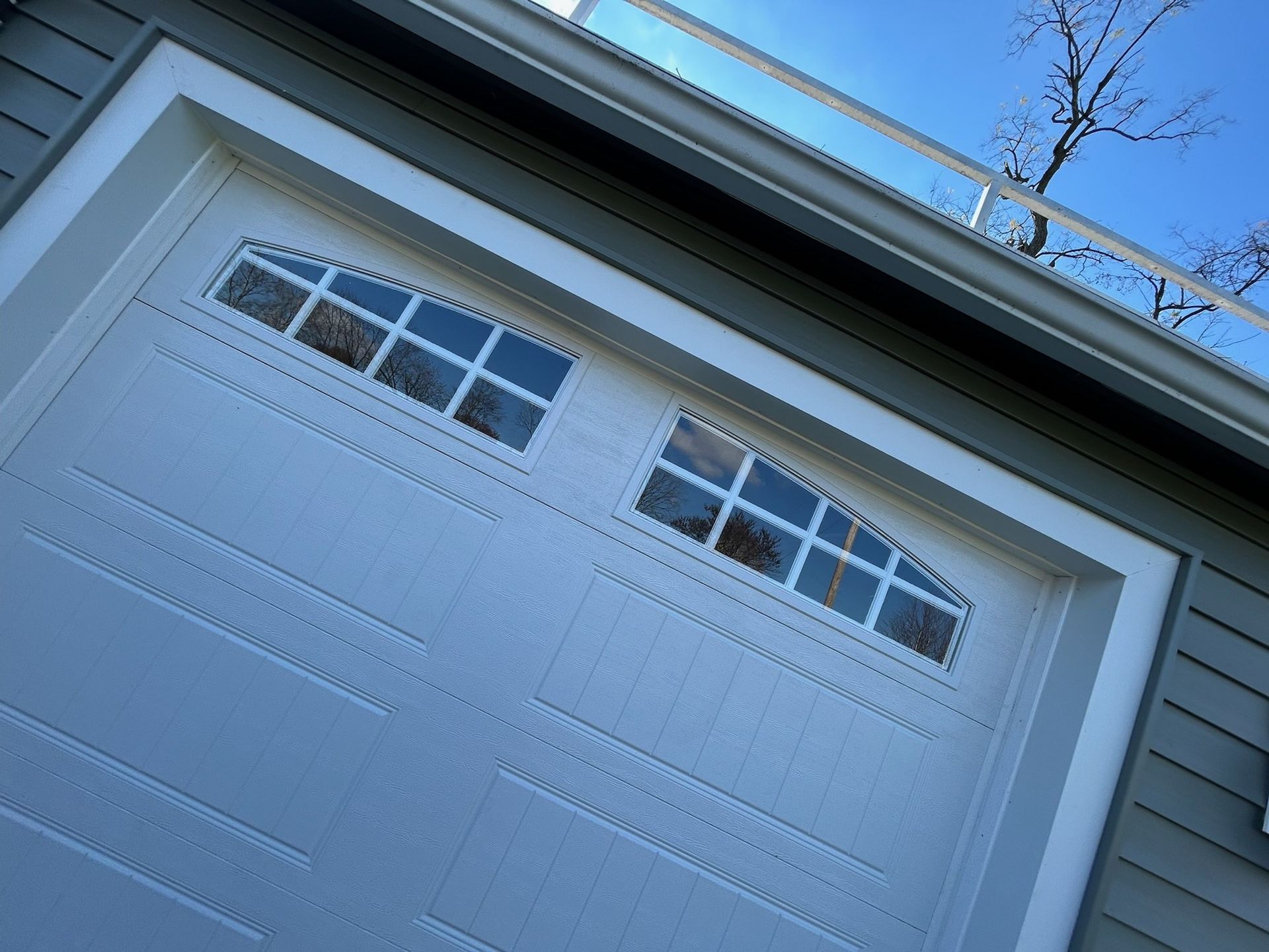 A close up of a white garage door on a house.