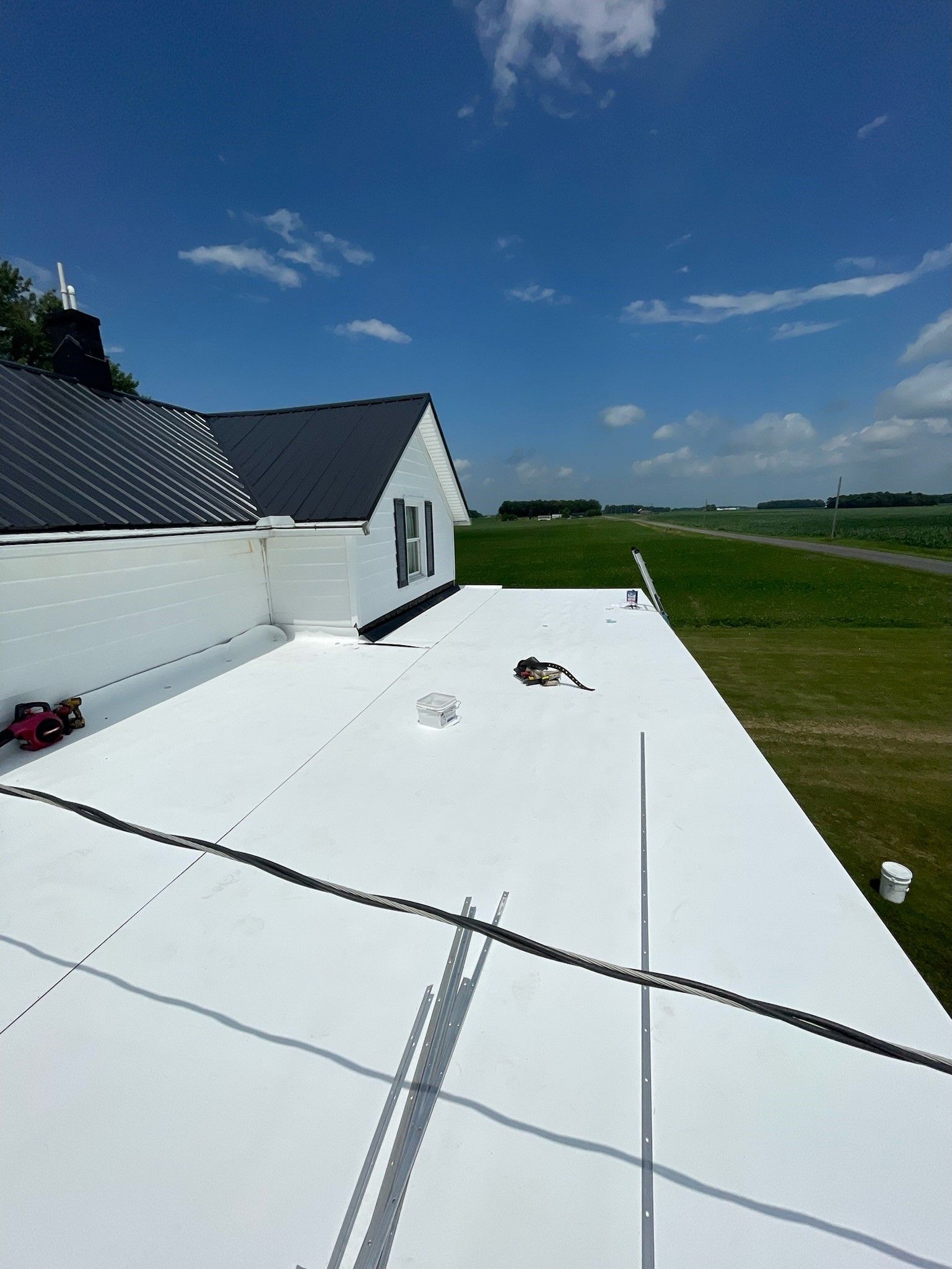 A white flat roof with a blue sky in the background