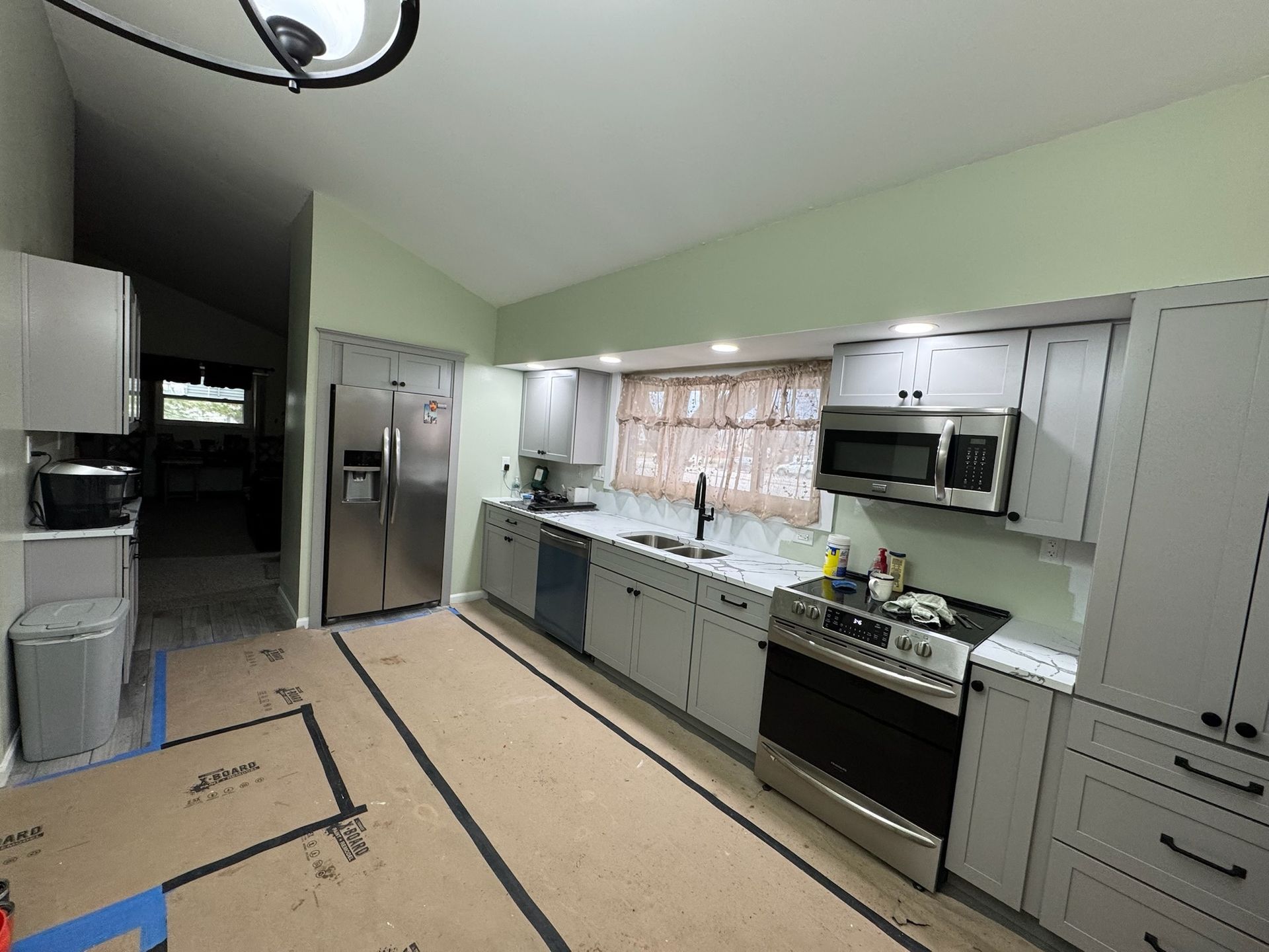 A kitchen with black cabinets and white counter tops