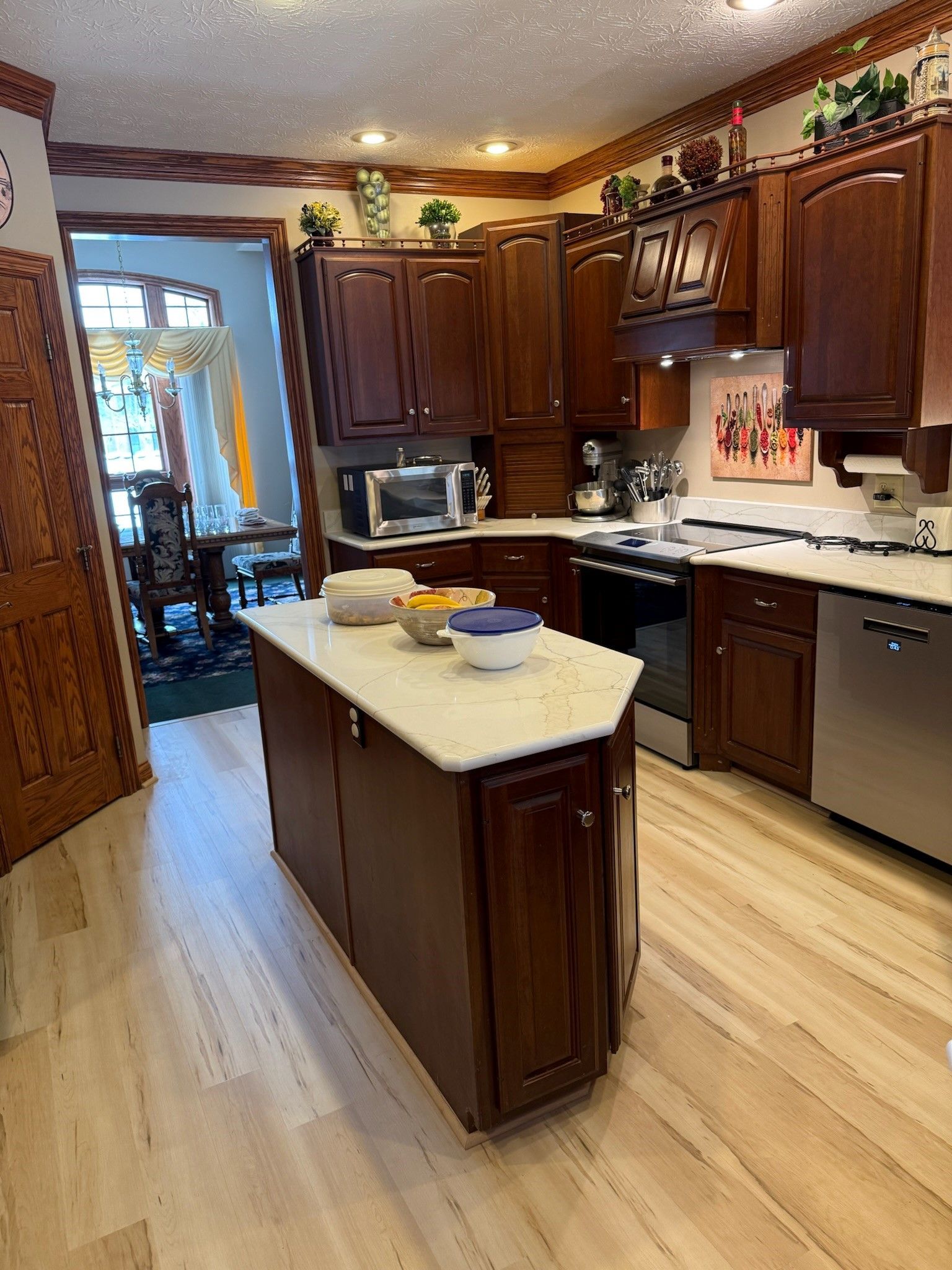 A kitchen with a sink, cabinets, and a window.