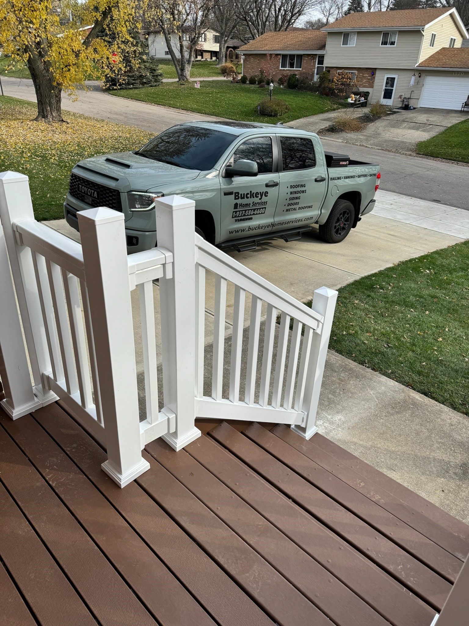 A truck is parked on the steps of a house.