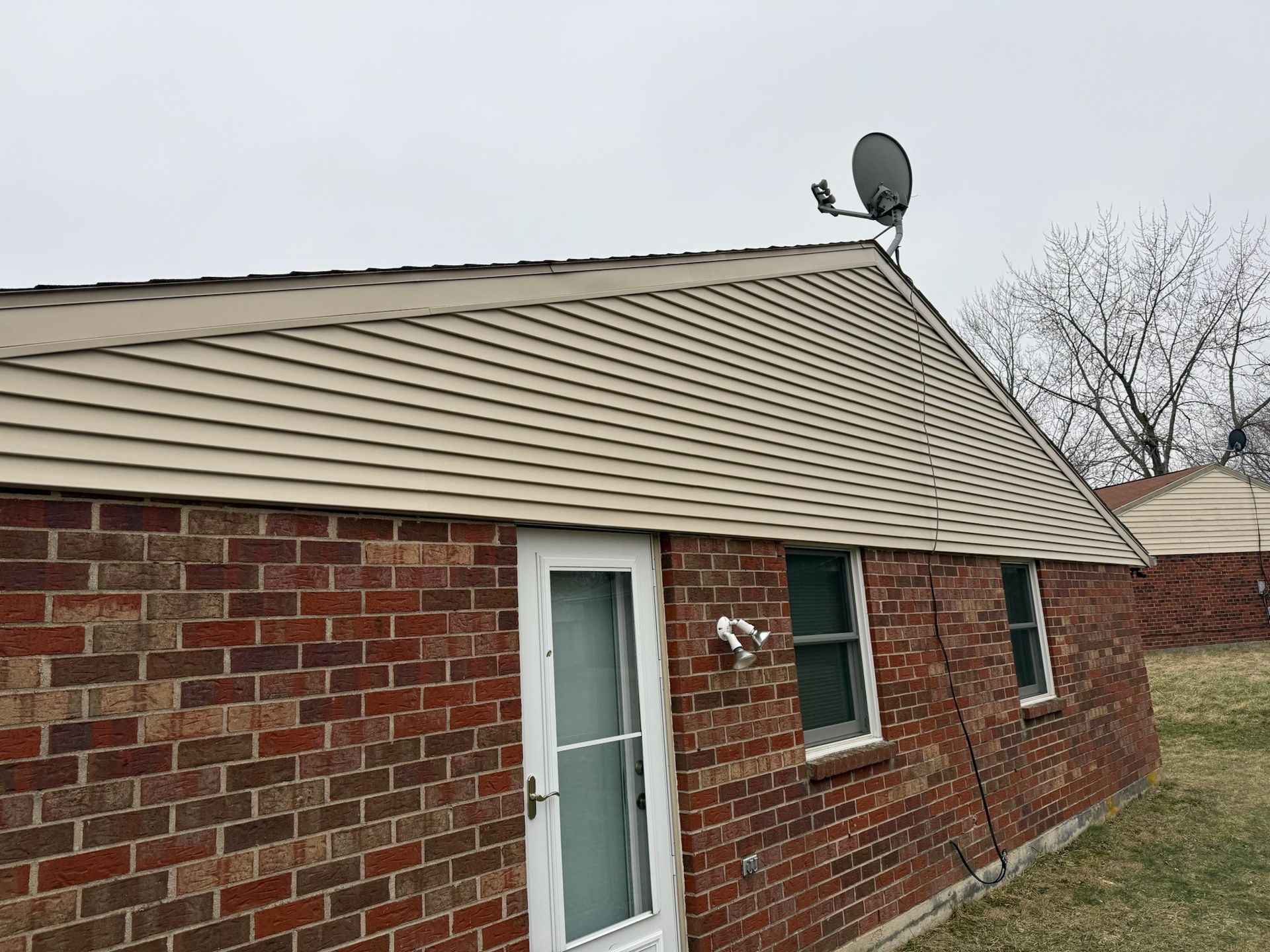 A mobile home with a porch and a green door.