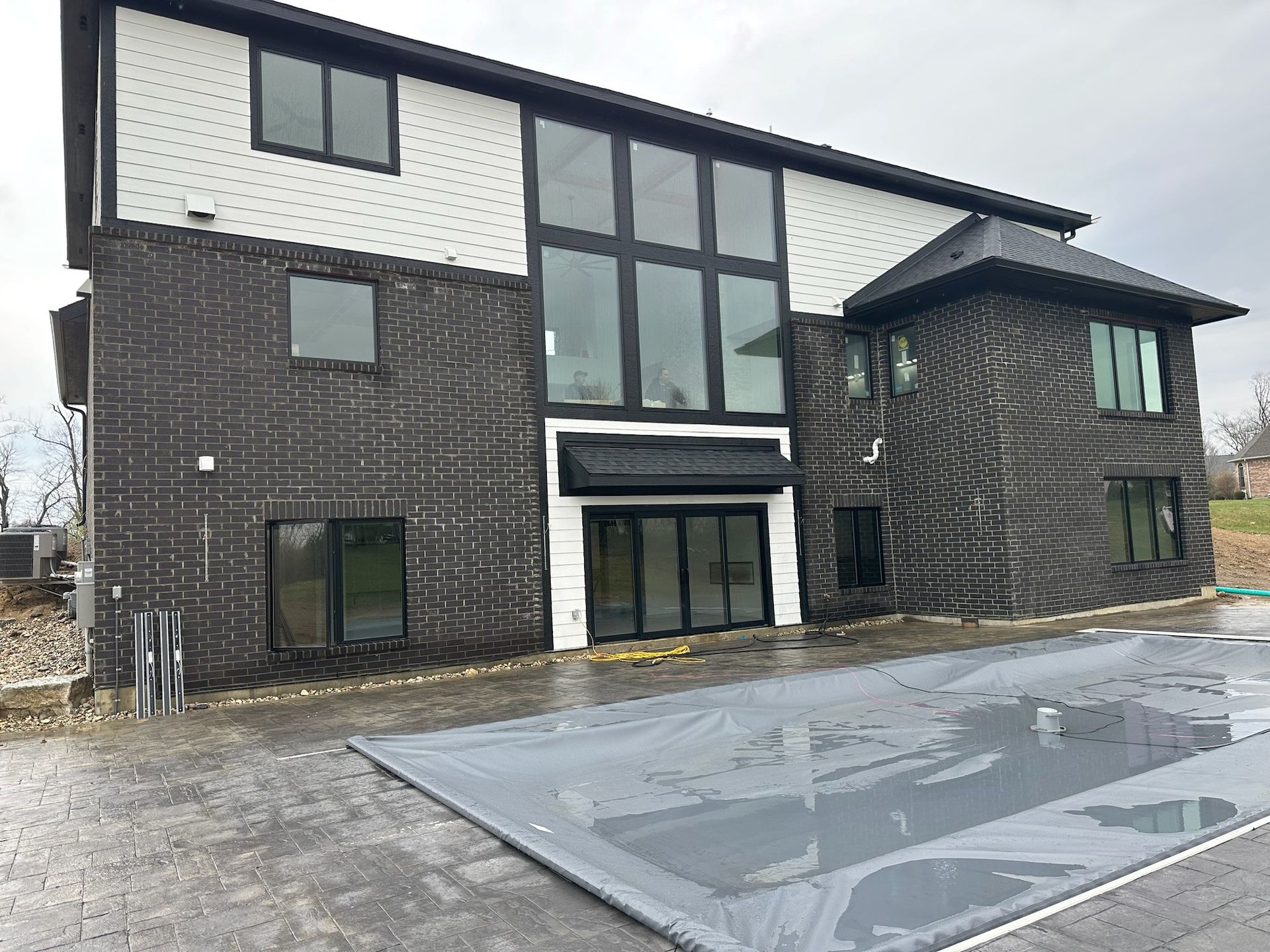 A large house with a swimming pool in front of it.