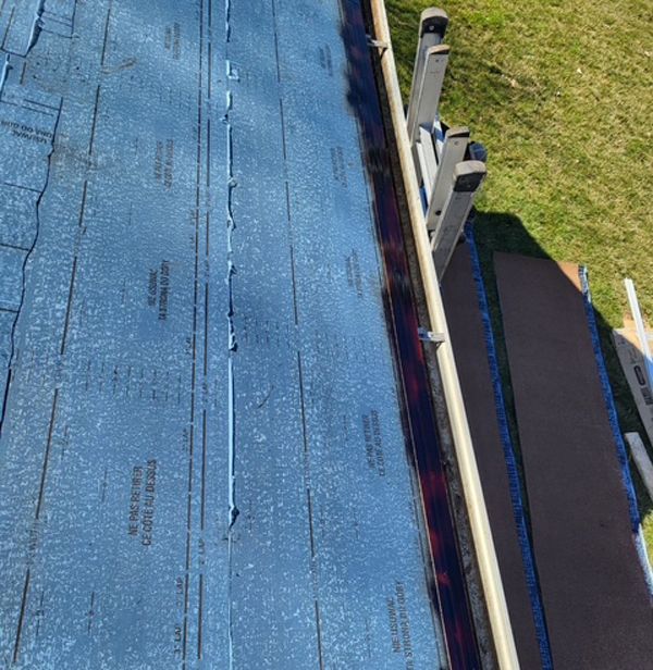 A blue roof is being installed on a house.