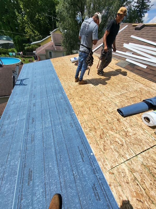 Roofer working on flat roof