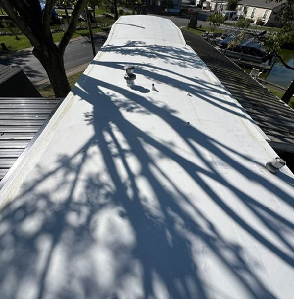 White flat roof with the shadow of a tree