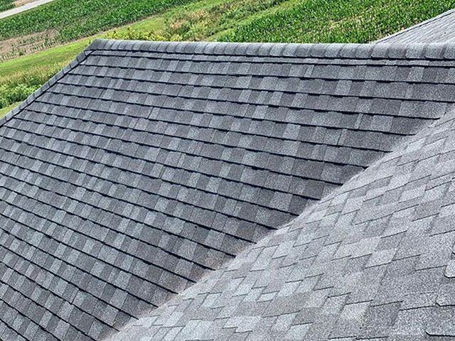 A close up of a roof with a lot of shingles on it.