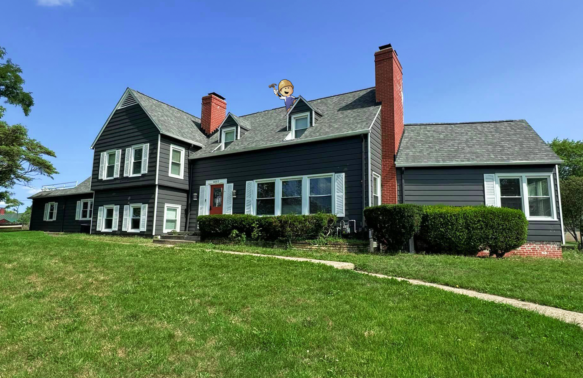 A large house with a lush green lawn in front of it.