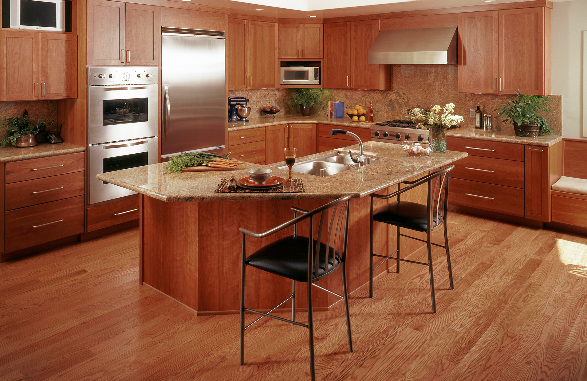 A kitchen with stainless steel appliances and wooden cabinets