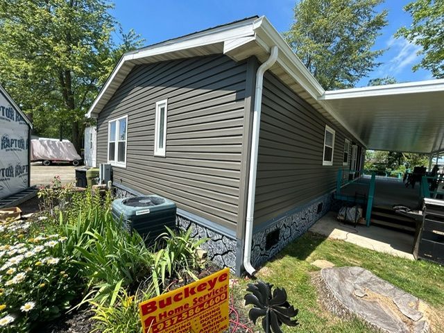 A mobile home with a buckeye sign in front of it.