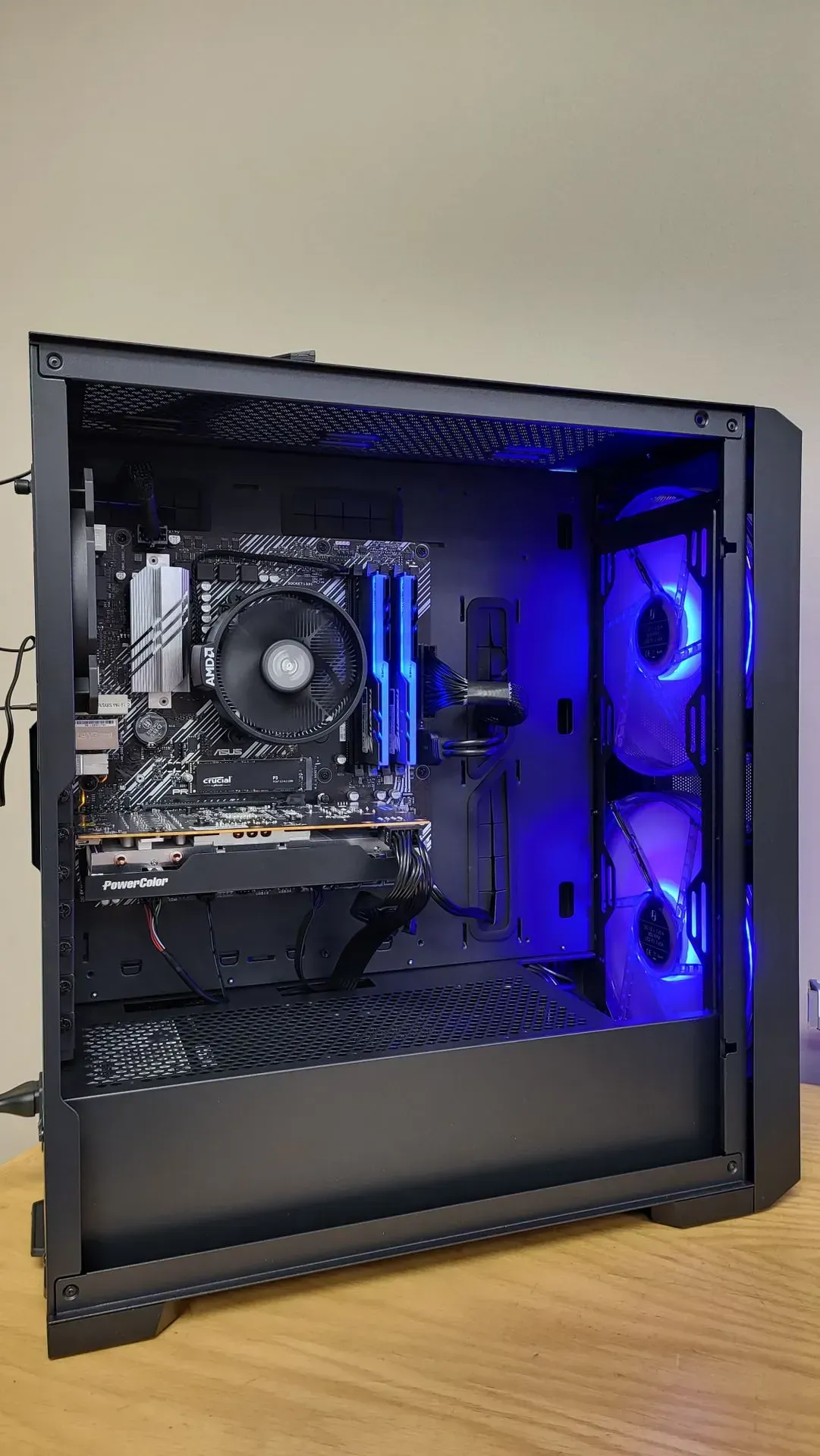 Black computer tower with blue interior lighting and components.