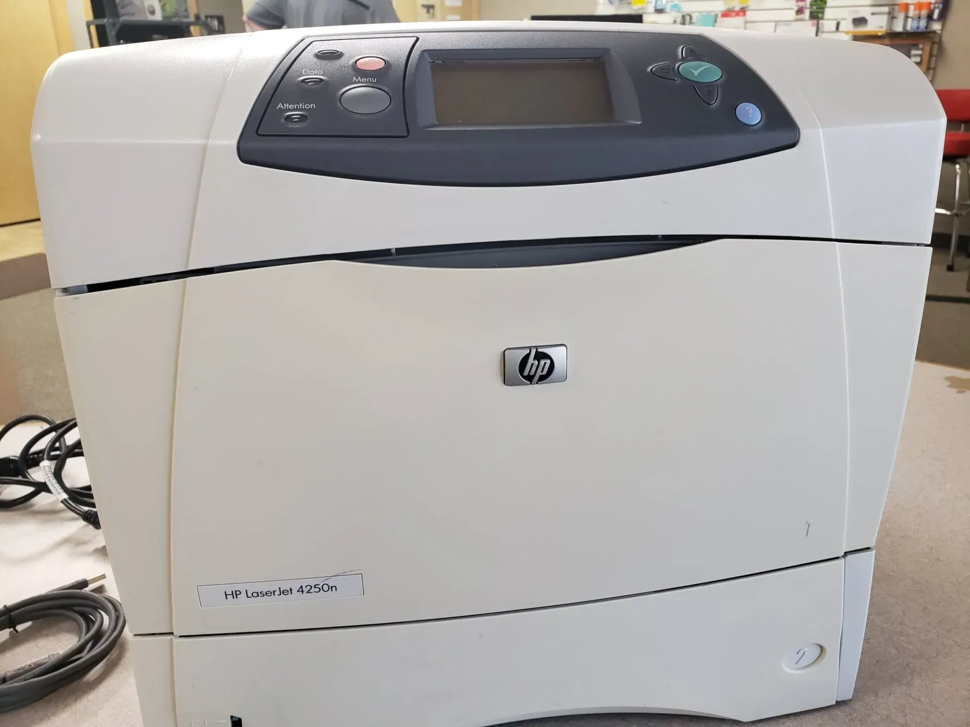 White HP laser printer with control panel on top.