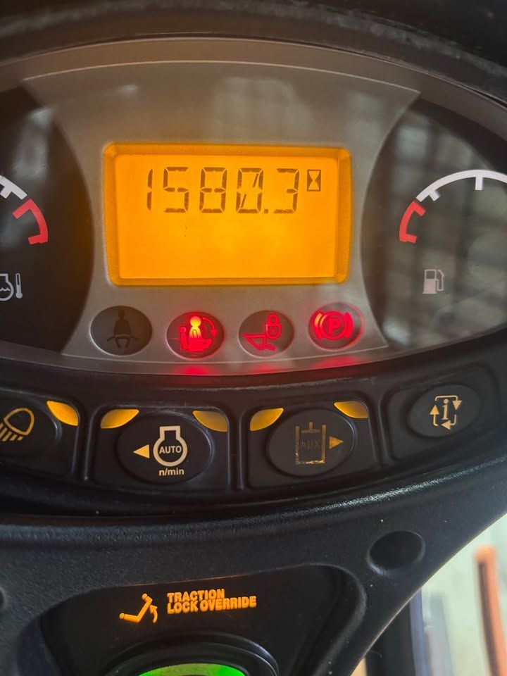 Dashboard with hour meter reading 1580.3, several warning lights illuminated, and fuel gauge.