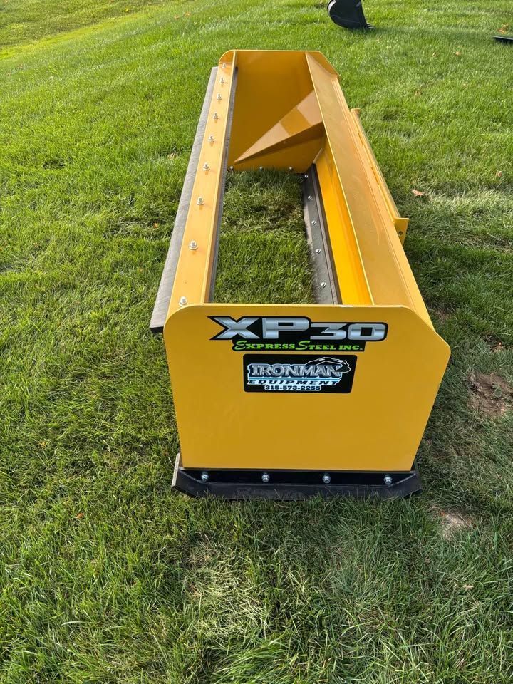 Yellow Snow Pusher with XP30 label on grass.