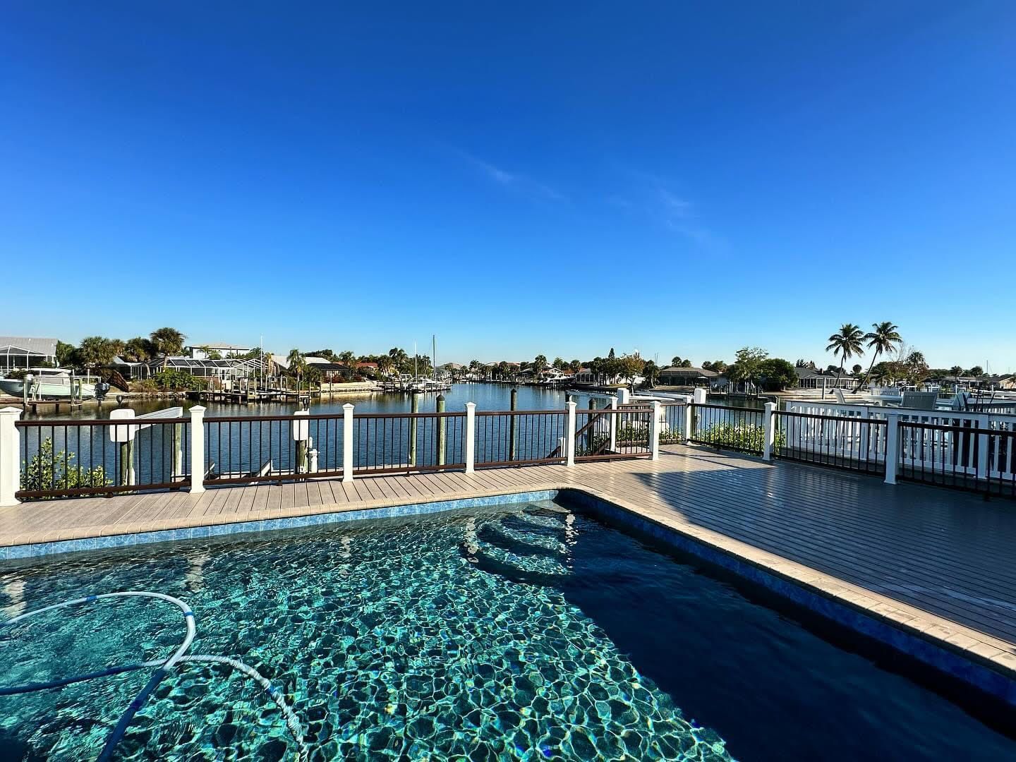 a large swimming pool with a view of a body of water