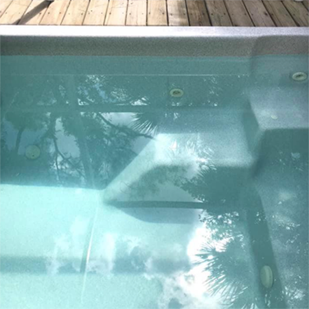 A wooden shed with a hot tub inside of it