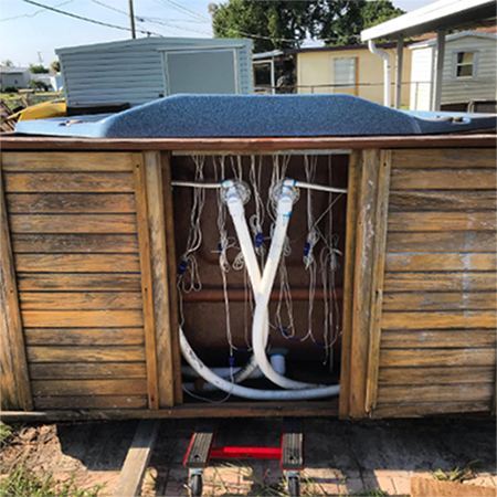 A swimming pool with a wooden deck in the background