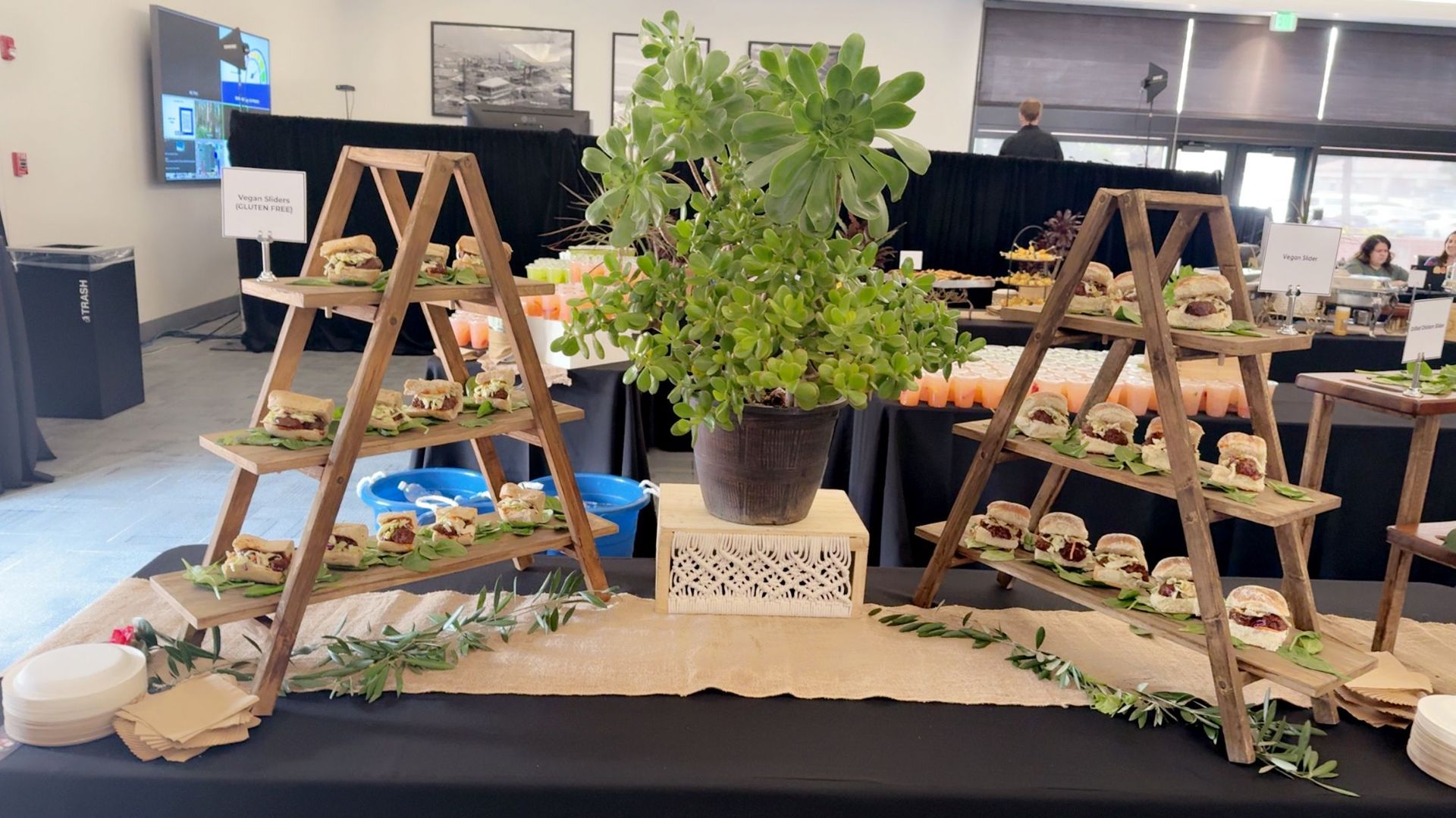 A wooden ladder filled with food is sitting on top of a table.