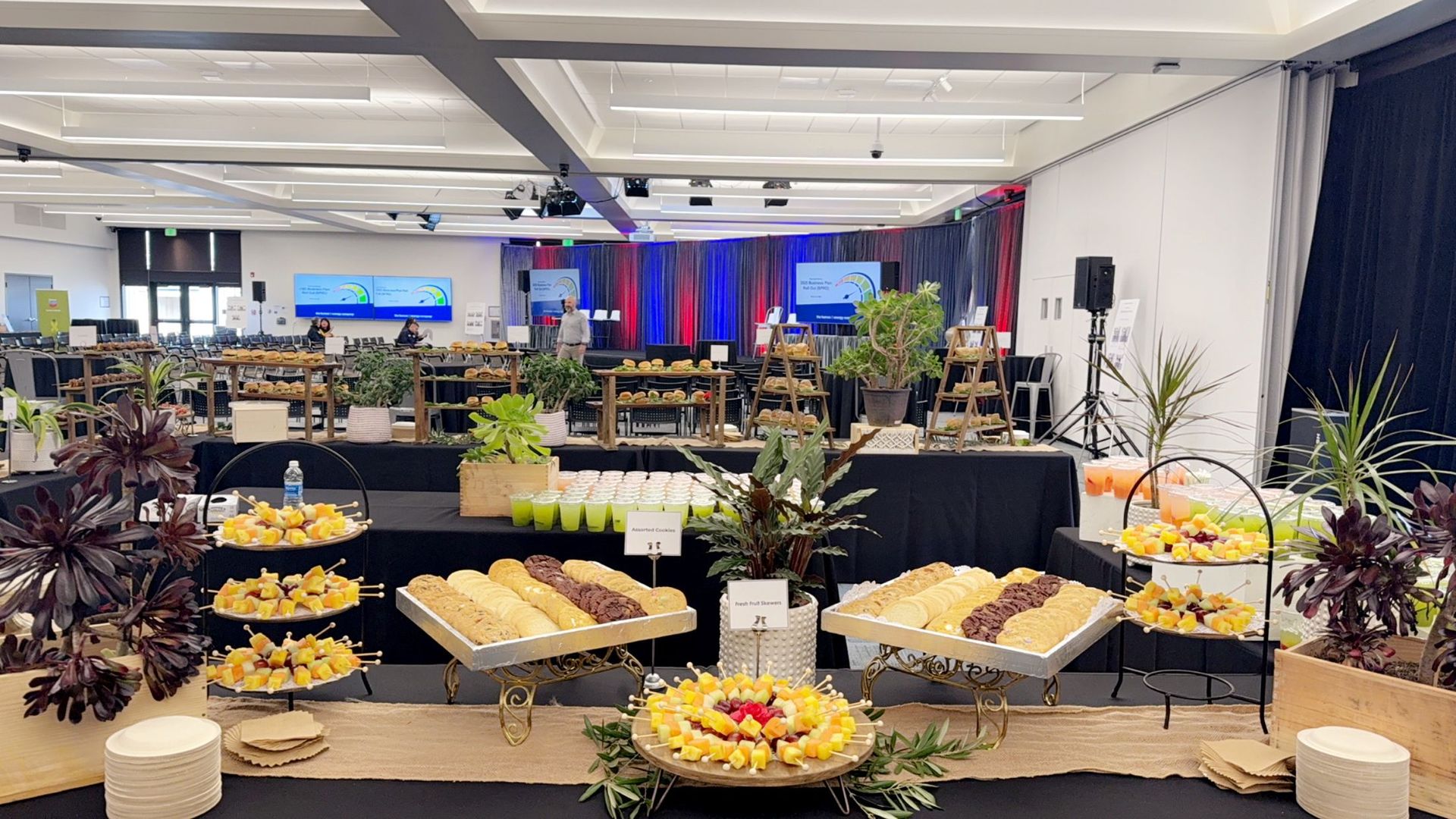 A large room filled with tables and plates of food.