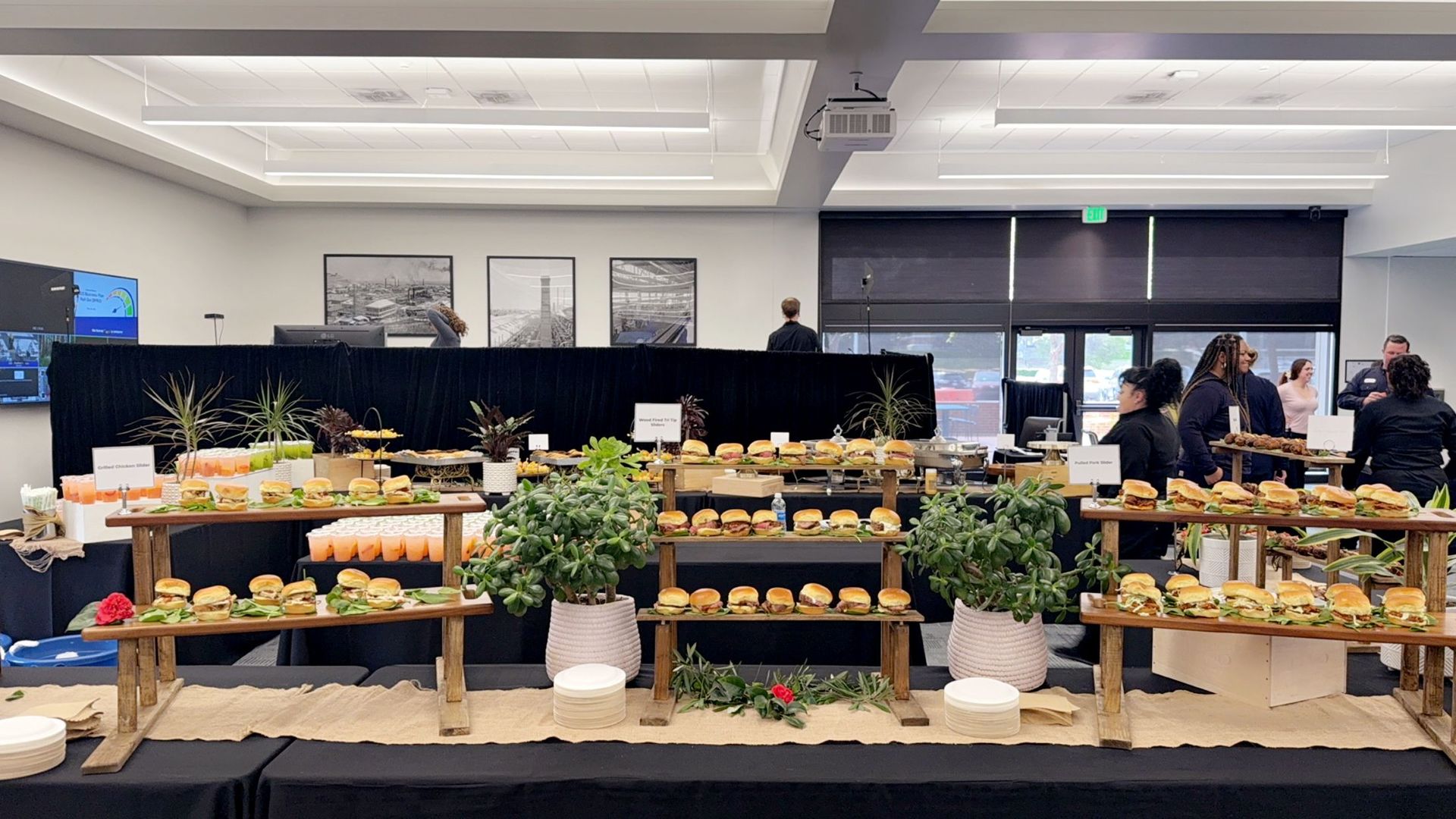 A large room with a buffet table filled with food.
