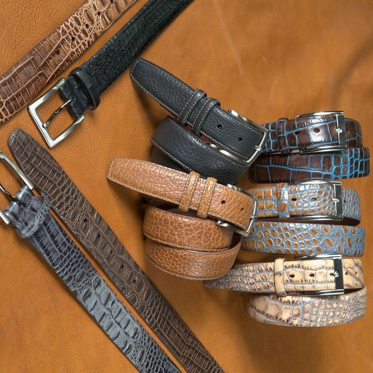 A variety of belts are stacked on top of each other