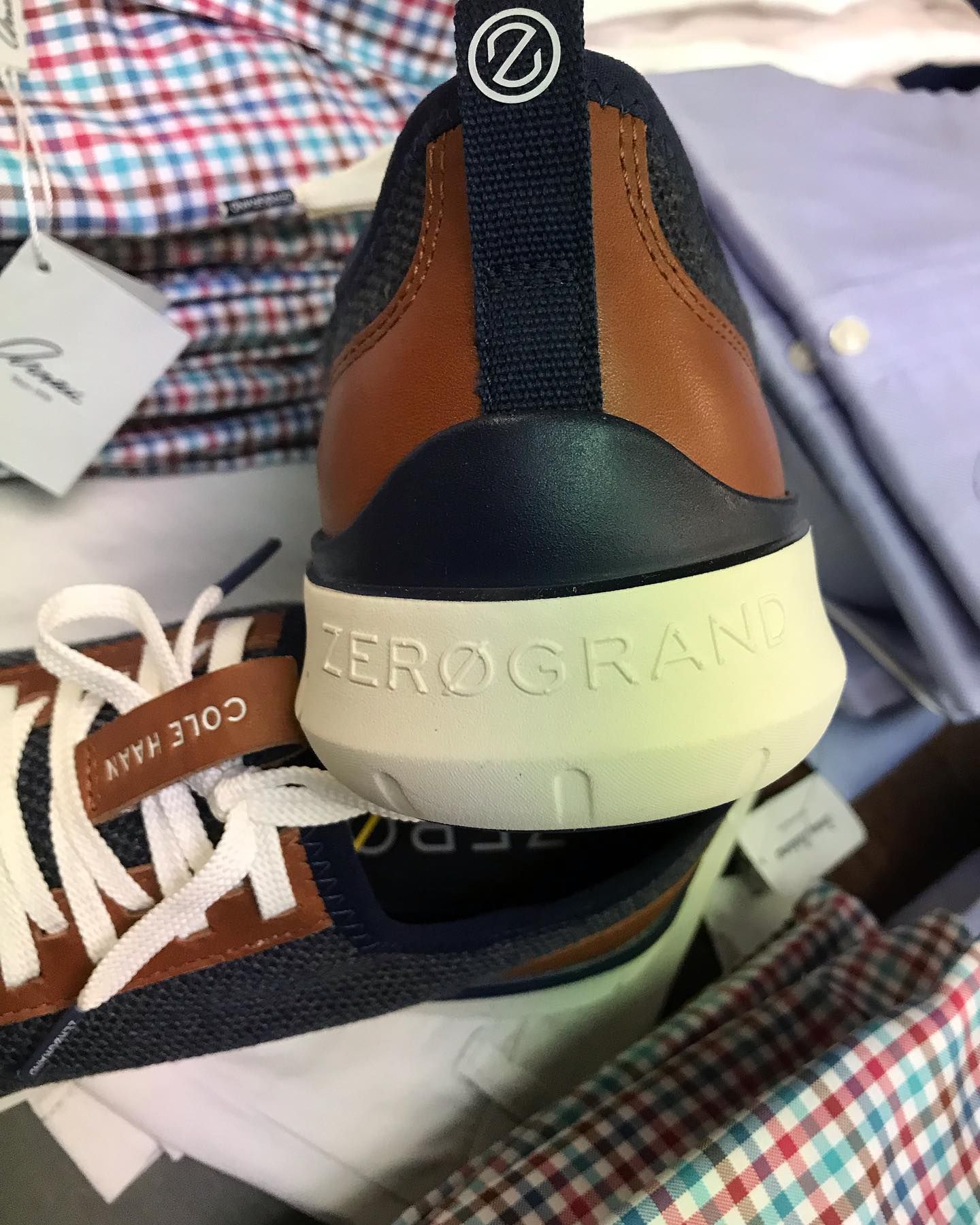 A pair of brown and black sneakers with the word zerogrand on the side.